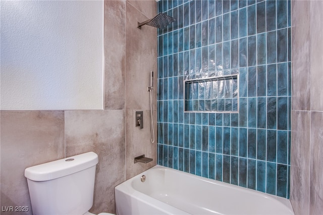 5653 Artesia Lake Ct, Las Vegas, NV 89118 - bathroom featuring toilet, tile walls, and shower / bathtub combination