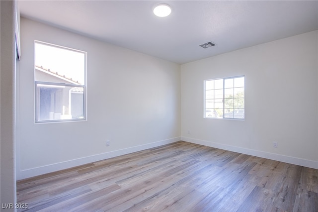 5653 Artesia Lake Ct, Las Vegas, NV 89118 - unfurnished room with light wood-style floors and baseboards