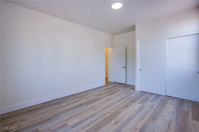 5653 Artesia Lake Ct, Las Vegas, NV 89118 - unfurnished bedroom with light wood-style flooring, a closet, and baseboards