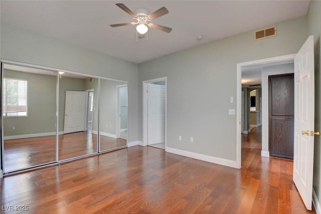 1405 S Nellis Blvd Unit 2117, Las Vegas, NV 89104 - unfurnished bedroom with wood finished floors, baseboards, and a ceiling fan