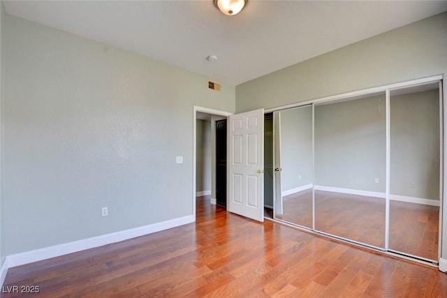 1405 S Nellis Blvd Unit 2117, Las Vegas, NV 89104 - unfurnished bedroom featuring wood finished floors, baseboards, and a closet