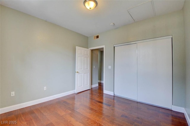 1405 S Nellis Blvd Unit 2117, Las Vegas, NV 89104 - unfurnished bedroom with wood finished floors, attic access, baseboards, and a closet