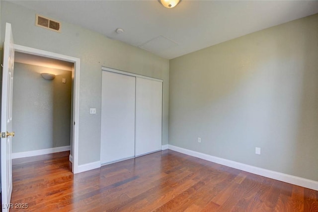 1405 S Nellis Blvd Unit 2117, Las Vegas, NV 89104 - unfurnished bedroom featuring wood finished floors, a closet, and baseboards