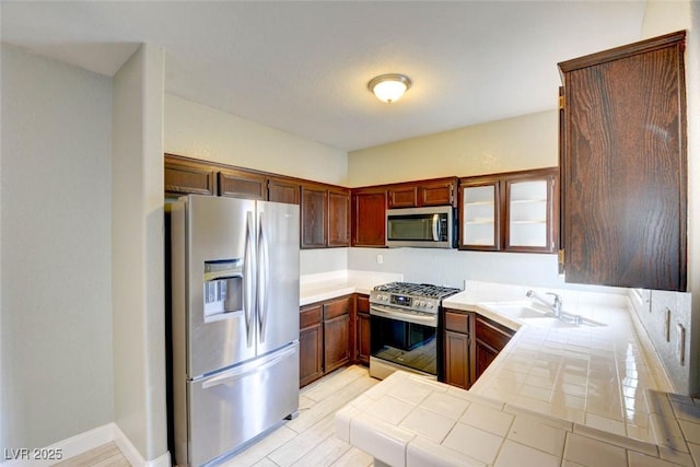 1405 S Nellis Blvd Unit 2117, Las Vegas, NV 89104 - kitchen featuring stainless steel appliances, a sink, tile countertops, and a peninsula