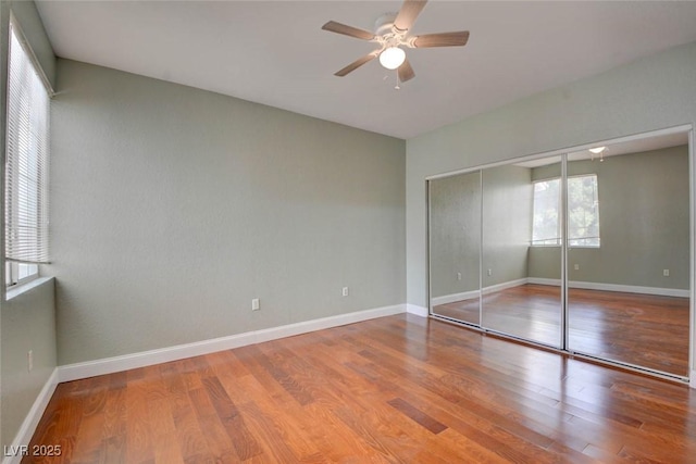 1405 S Nellis Blvd Unit 2117, Las Vegas, NV 89104 - unfurnished bedroom featuring wood finished floors, baseboards, a closet, and a ceiling fan