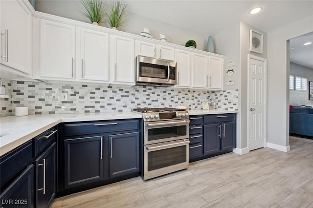 2425 Sturrock Dr, Henderson, NV 89044 - kitchen with appliances with stainless steel finishes, white cabinetry, recessed lighting, light countertops, and tasteful backsplash