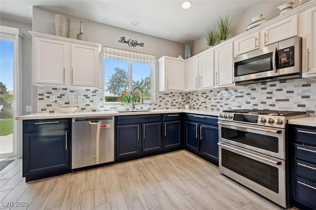 2425 Sturrock Dr, Henderson, NV 89044 - kitchen featuring stainless steel appliances, white cabinets, a sink, and recessed lighting