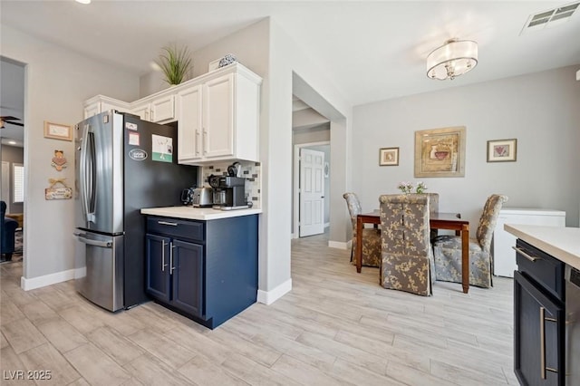 2425 Sturrock Dr, Henderson, NV 89044 - kitchen featuring freestanding refrigerator, white cabinets, light countertops, and light wood-style floors