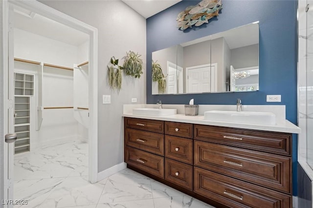2425 Sturrock Dr, Henderson, NV 89044 - full bath with double vanity, a walk in closet, marble finish floors, and baseboards
