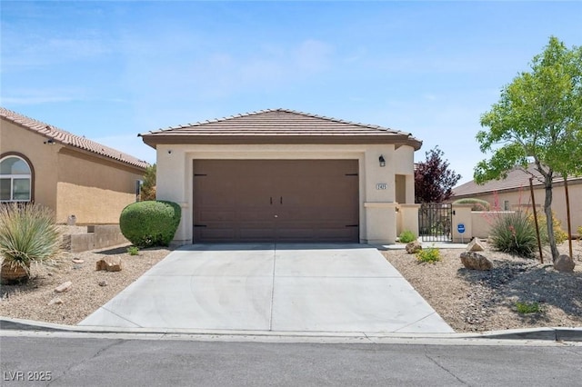 2425 Sturrock Dr, Henderson, NV 89044 - view of front of home with concrete driveway, stucco siding, a tile roof, an attached garage, and a gate