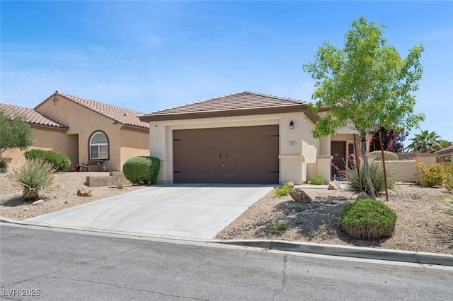 2425 Sturrock Dr, Henderson, NV 89044 - view of front of property featuring an attached garage, stucco siding, concrete driveway, and a tiled roof