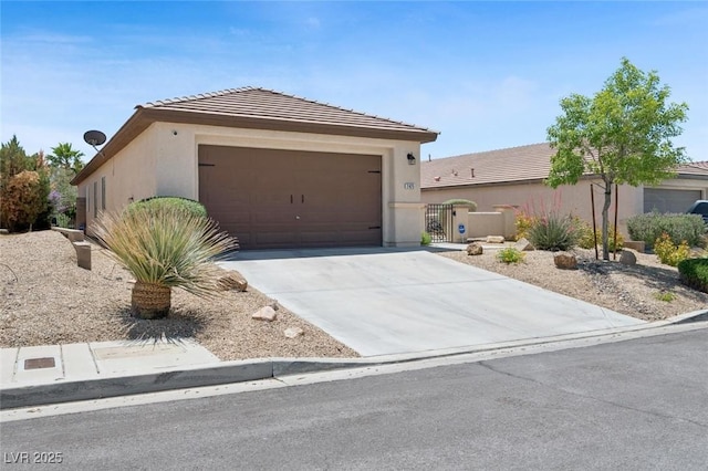 2425 Sturrock Dr, Henderson, NV 89044 - single story home featuring concrete driveway, stucco siding, an attached garage, and a tiled roof