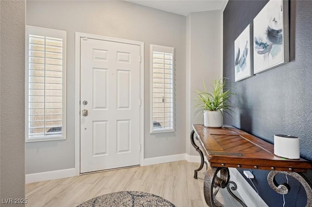 2425 Sturrock Dr, Henderson, NV 89044 - entryway with light wood finished floors, baseboards, and plenty of natural light