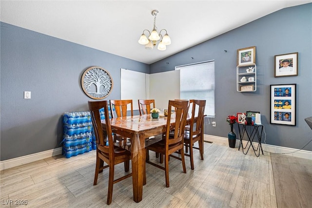 320 W Van Buren Ave, Las Vegas, NV 89106 - dining area featuring vaulted ceiling, a chandelier, light wood-style flooring, and baseboards