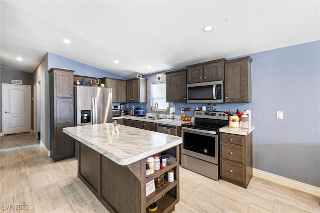 320 W Van Buren Ave, Las Vegas, NV 89106 - kitchen featuring appliances with stainless steel finishes, open shelves, lofted ceiling, dark brown cabinets, and light countertops