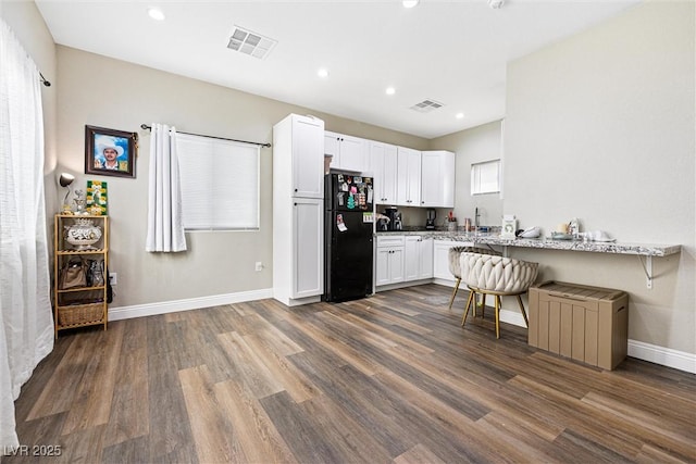 320 W Van Buren Ave, Las Vegas, NV 89106 - kitchen with freestanding refrigerator, dark wood-style flooring, white cabinetry, baseboards, and recessed lighting