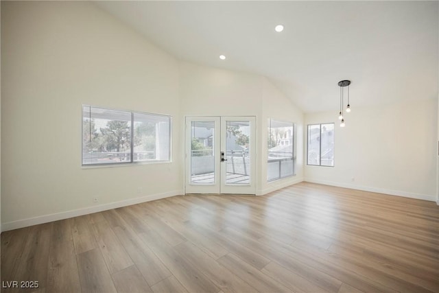 5516 Orchard Ln Unit 0, Las Vegas, NV 89110 - unfurnished living room with light wood-type flooring, baseboards, recessed lighting, high vaulted ceiling, and french doors