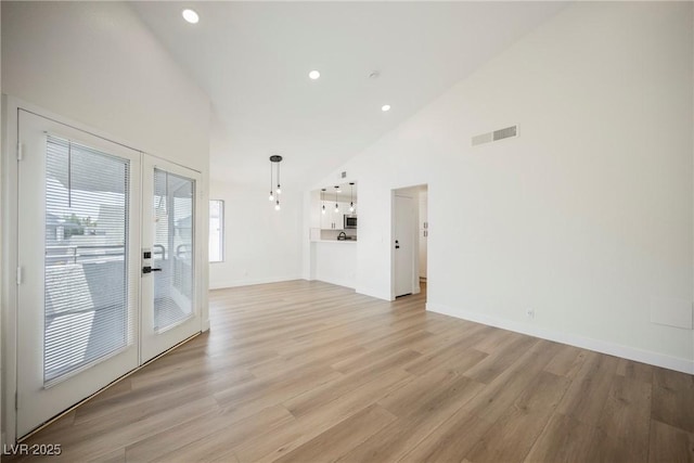 5516 Orchard Ln Unit 0, Las Vegas, NV 89110 - unfurnished living room featuring french doors, light wood finished floors, high vaulted ceiling, recessed lighting, and baseboards