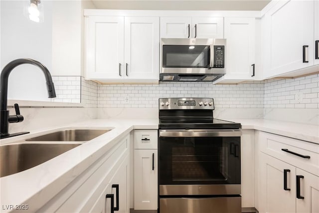 5516 Orchard Ln Unit 0, Las Vegas, NV 89110 - kitchen featuring stainless steel appliances, a sink, white cabinets, and tasteful backsplash