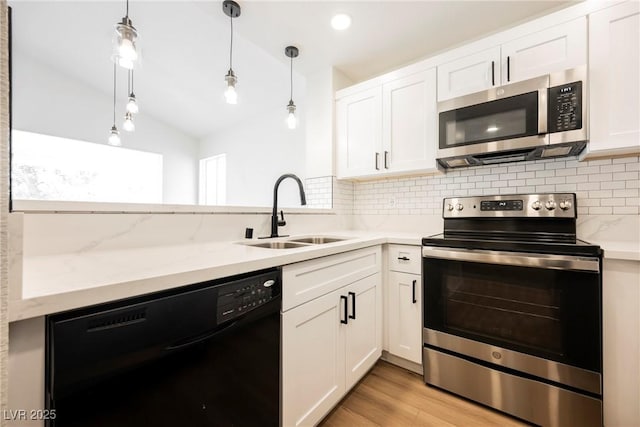 5516 Orchard Ln Unit 0, Las Vegas, NV 89110 - kitchen with appliances with stainless steel finishes, a sink, tasteful backsplash, vaulted ceiling, and white cabinets