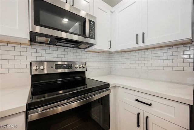 5516 Orchard Ln Unit 0, Las Vegas, NV 89110 - kitchen with stainless steel appliances, white cabinetry, tasteful backsplash, and light stone counters
