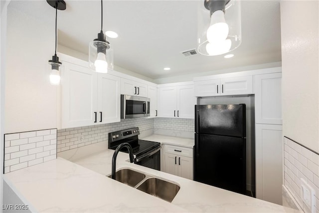 5516 Orchard Ln Unit 0, Las Vegas, NV 89110 - kitchen with freestanding refrigerator, stainless steel microwave, electric range oven, a sink, and white cabinetry