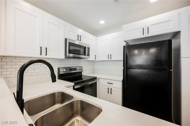 5516 Orchard Ln Unit 0, Las Vegas, NV 89110 - kitchen with appliances with stainless steel finishes, a sink, white cabinets, tasteful backsplash, and recessed lighting