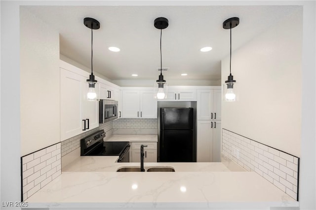 5516 Orchard Ln Unit 0, Las Vegas, NV 89110 - kitchen with appliances with stainless steel finishes, a sink, light stone counters, decorative backsplash, and hanging light fixtures