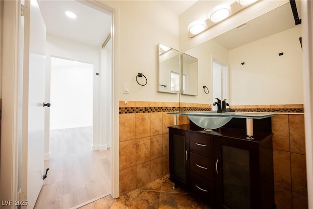 5516 Orchard Ln Unit 0, Las Vegas, NV 89110 - bathroom featuring tile walls, vanity, and wainscoting