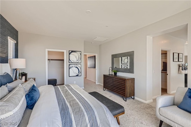 9588 Archer Peak Ct, Las Vegas, NV 89143 - bedroom featuring a walk in closet, a closet, light carpet, and baseboards