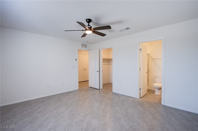 6288 Dolosonte St, Las Vegas, NV 89113 - unfurnished bedroom featuring a spacious closet, baseboards, a closet, a ceiling fan, and ensuite bath