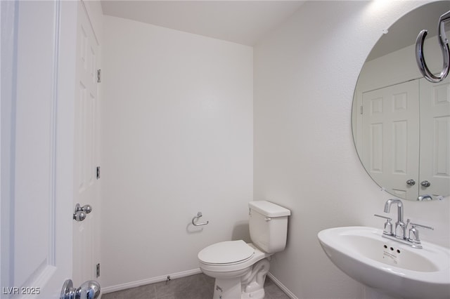 6288 Dolosonte St, Las Vegas, NV 89113 - half bath featuring a sink, toilet, baseboards, and tile patterned flooring