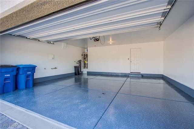 6288 Dolosonte St, Las Vegas, NV 89113 - garage with baseboards and a garage door opener