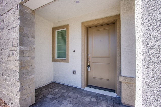 6288 Dolosonte St, Las Vegas, NV 89113 - doorway to property with stucco siding