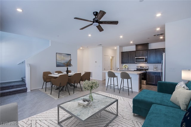 6288 Dolosonte St, Las Vegas, NV 89113 - living room featuring stairway, ceiling fan, recessed lighting, and baseboards