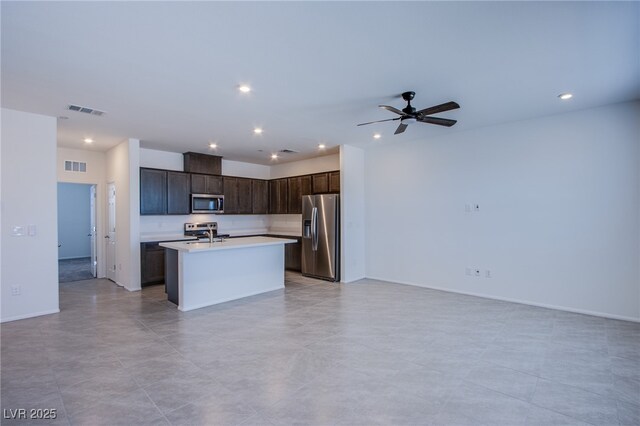6288 Dolosonte St, Las Vegas, NV 89113 - kitchen featuring appliances with stainless steel finishes, open floor plan, light countertops, recessed lighting, and dark brown cabinetry