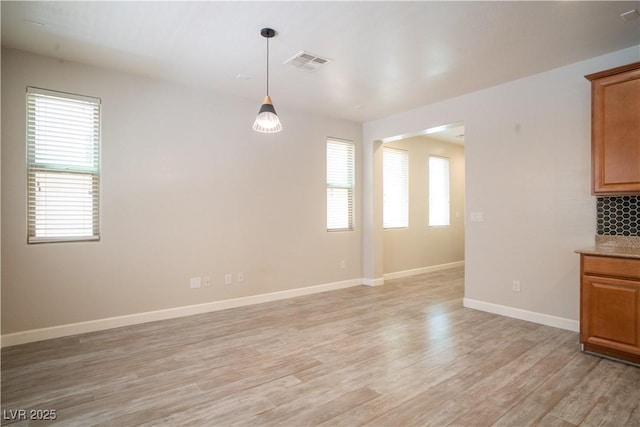 7715 Peaceful Trellis Dr, Las Vegas, NV 89179 - spare room with light wood finished floors and baseboards