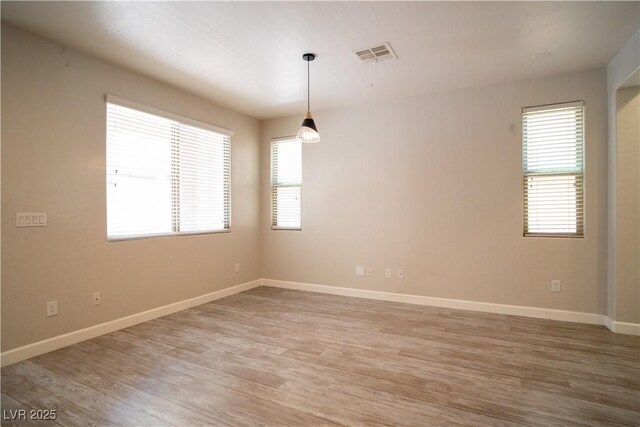 7715 Peaceful Trellis Dr, Las Vegas, NV 89179 - unfurnished room featuring light wood-style floors and baseboards