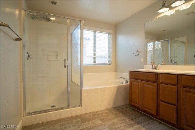 7715 Peaceful Trellis Dr, Las Vegas, NV 89179 - full bath featuring vanity, a stall shower, a bath, and wood finished floors