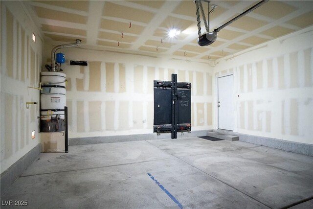 7715 Peaceful Trellis Dr, Las Vegas, NV 89179 - garage featuring a garage door opener, a central vacuum unit, and baseboards
