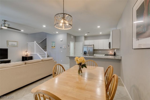 2870 Turnstone Ridge St, Henderson, NV 89044 - dining room with light tile patterned floors, stairway, recessed lighting, baseboards, and a chandelier