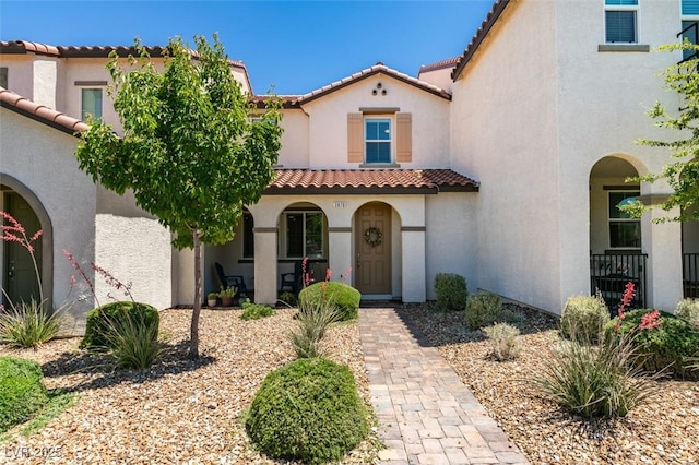 2870 Turnstone Ridge St, Henderson, NV 89044 - mediterranean / spanish-style house featuring covered porch, a tile roof, and stucco siding