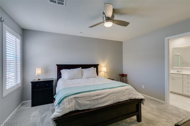 2870 Turnstone Ridge St, Henderson, NV 89044 - bedroom featuring light carpet, baseboards, and connected bathroom