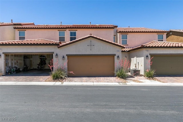 2870 Turnstone Ridge St, Henderson, NV 89044 - mediterranean / spanish house with an attached garage, decorative driveway, and stucco siding