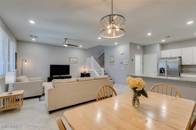2870 Turnstone Ridge St, Henderson, NV 89044 - dining room with light tile patterned floors, stairs, recessed lighting, ceiling fan, and baseboards
