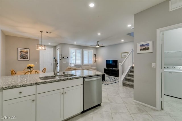 2870 Turnstone Ridge St, Henderson, NV 89044 - kitchen featuring stainless steel dishwasher, a sink, light stone countertops, white cabinetry, and recessed lighting