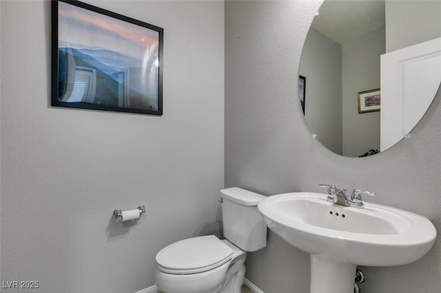 2870 Turnstone Ridge St, Henderson, NV 89044 - bathroom featuring toilet, baseboards, and a sink