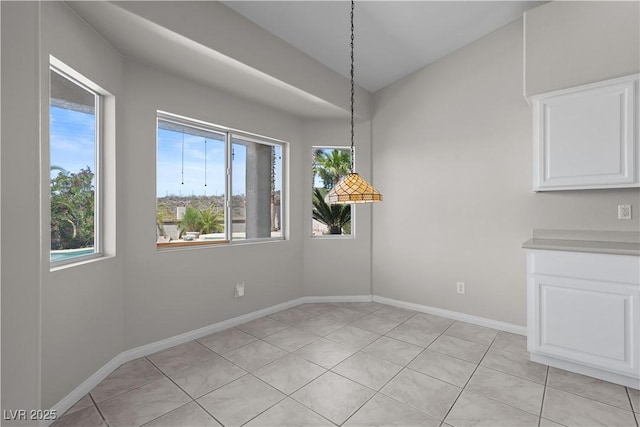 2158 Shubert Ave, Henderson, NV 89052 - unfurnished dining area with healthy amount of natural light, baseboards, and light tile patterned floors