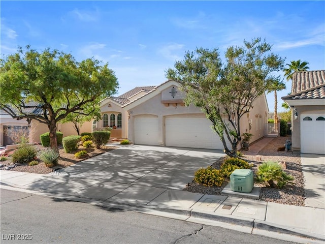2158 Shubert Ave, Henderson, NV 89052 - mediterranean / spanish home featuring stucco siding, a tile roof, a garage, and concrete driveway