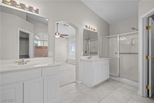 2158 Shubert Ave, Henderson, NV 89052 - bathroom featuring a ceiling fan, a stall shower, two vanities, tile patterned flooring, and lofted ceiling